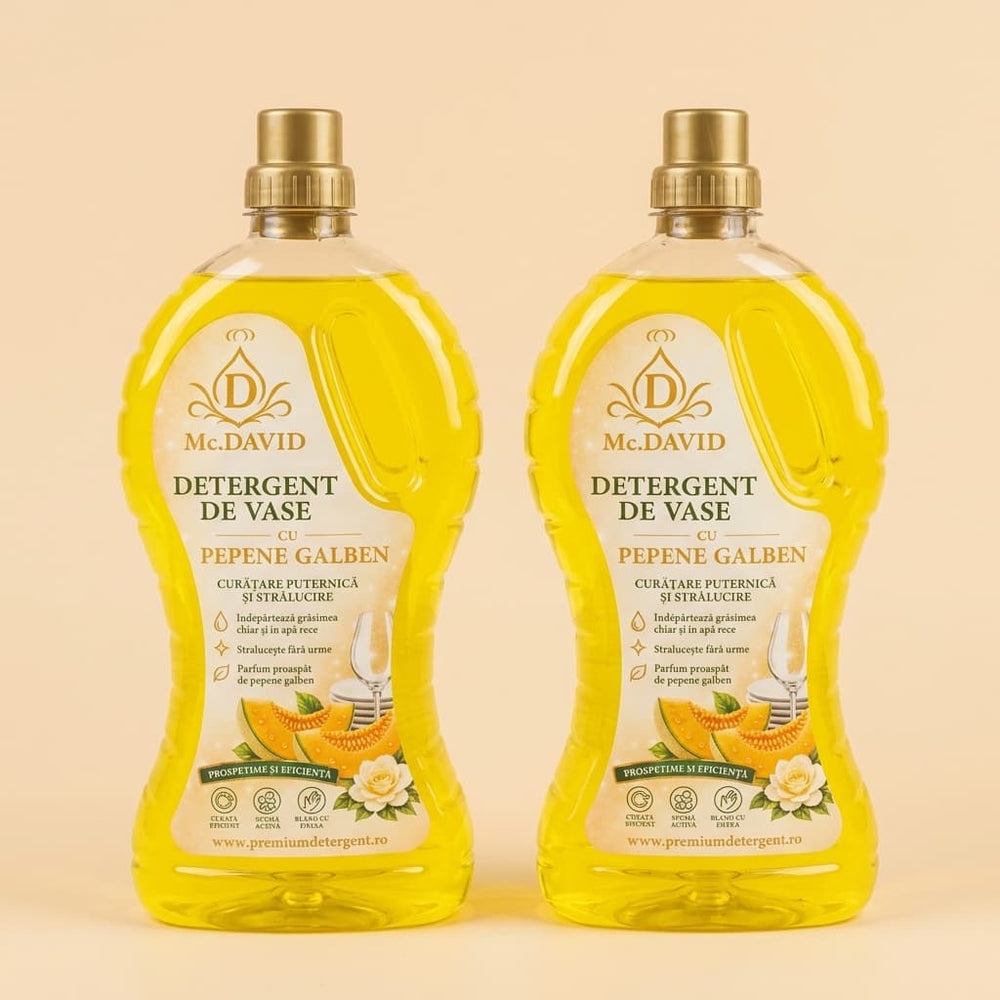 Detergent de vase Mc. David cu pepene galben, flacon transparent cu lichid galben și dop auriu, pe fundal crem